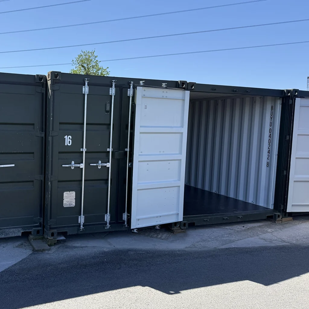 Row of green shipping/storage containers with one open door for the error 404 page