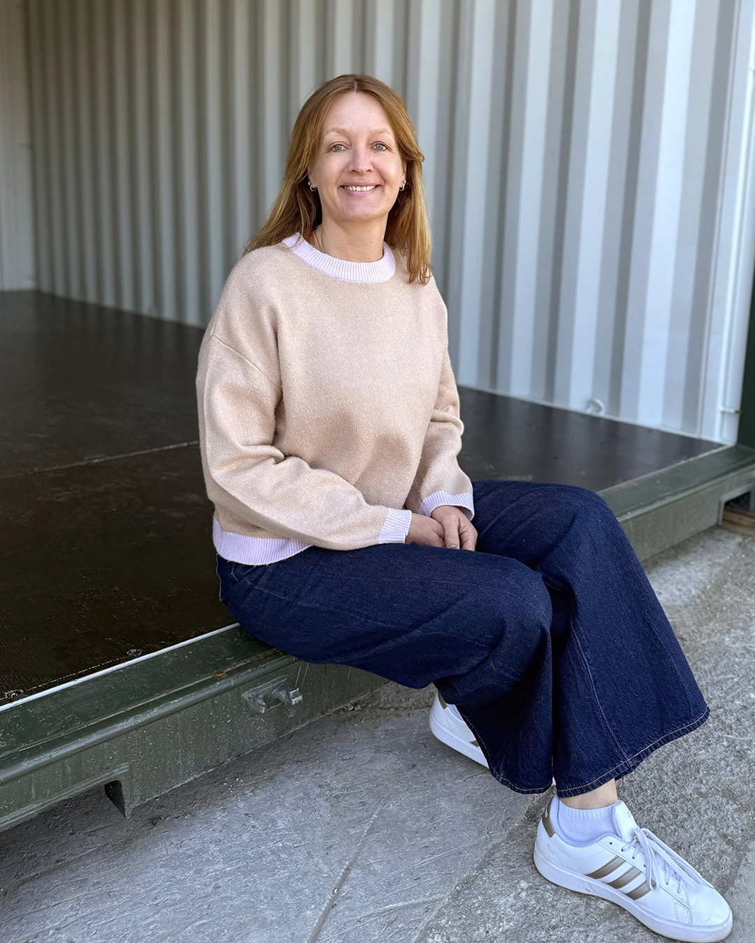 Portrait of Rachel Perdoni sitting inside shipping container storage in Croydon
